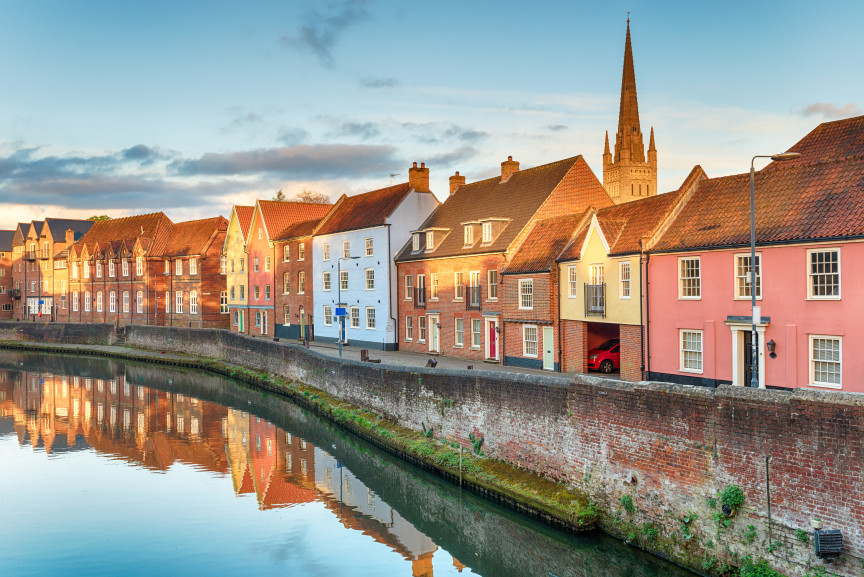 Colourful houses and Norwich Cathedral along the River Wensum