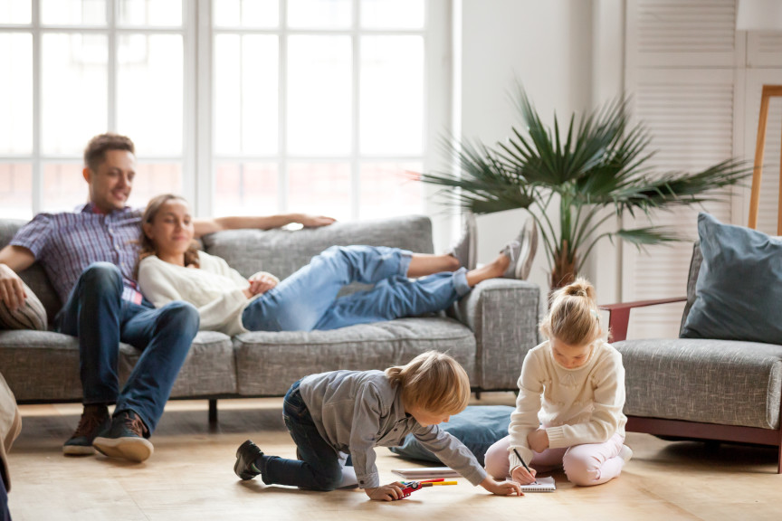 Young family lounging in their living area