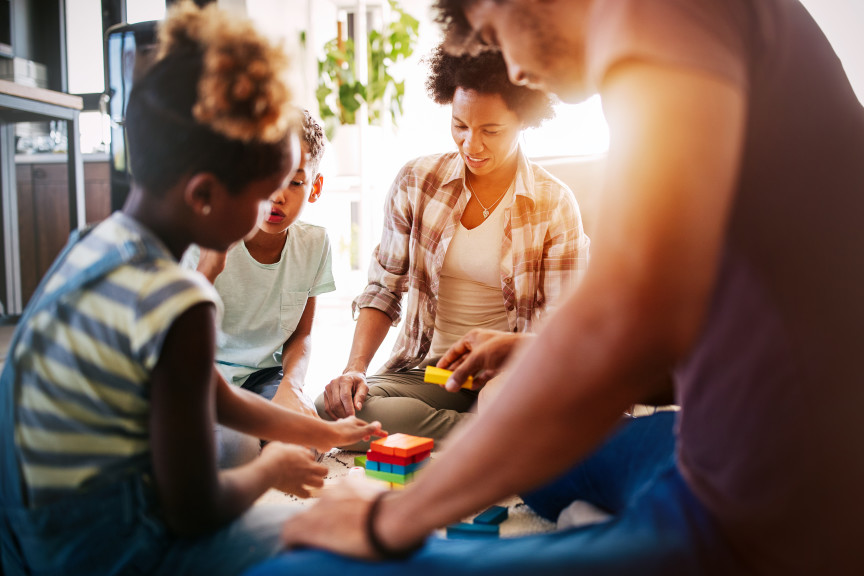 Happy family playing board game at home